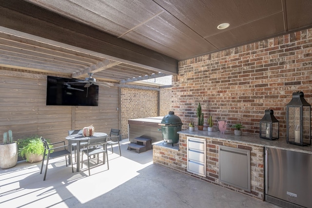 view of patio / terrace featuring exterior kitchen and ceiling fan