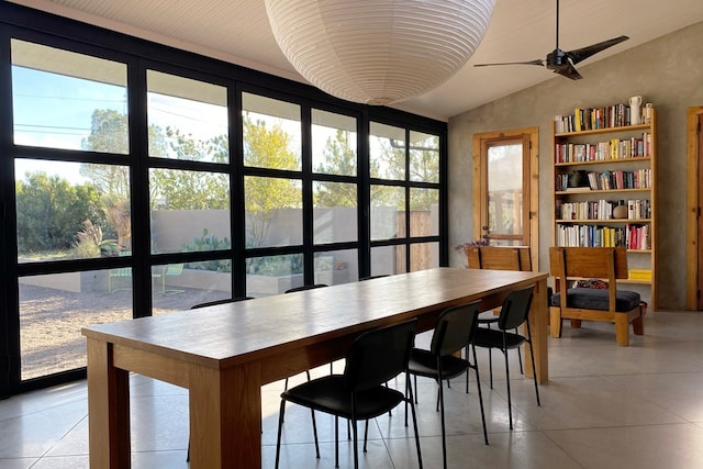 dining space featuring plenty of natural light, ceiling fan, lofted ceiling, and light tile patterned floors