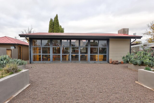 back of house with a sunroom