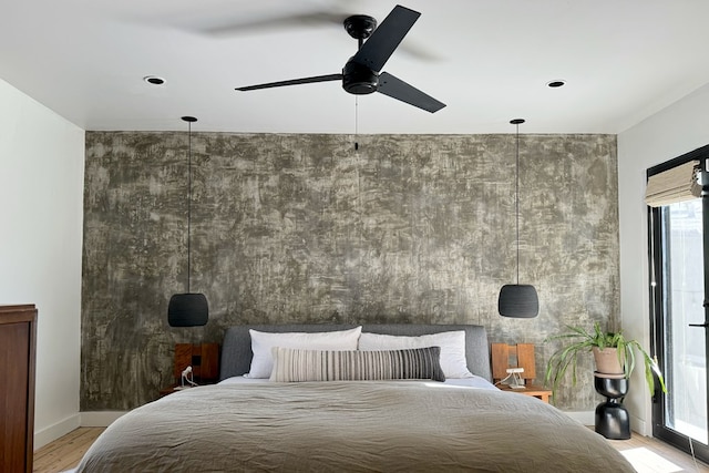 bedroom with ceiling fan and hardwood / wood-style floors