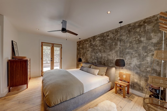 bedroom with french doors, light hardwood / wood-style flooring, and ceiling fan