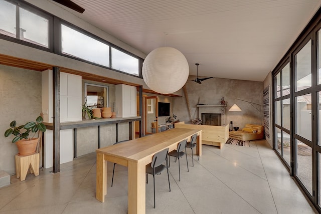 dining area featuring a towering ceiling and a healthy amount of sunlight