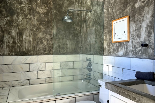 bathroom with tiled shower / bath combo and vanity