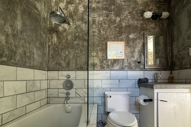 bathroom featuring vanity, toilet, and tile walls