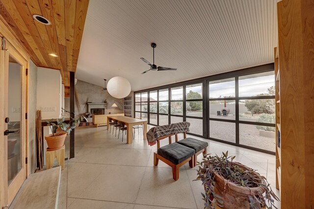 sunroom / solarium featuring ceiling fan and wooden ceiling