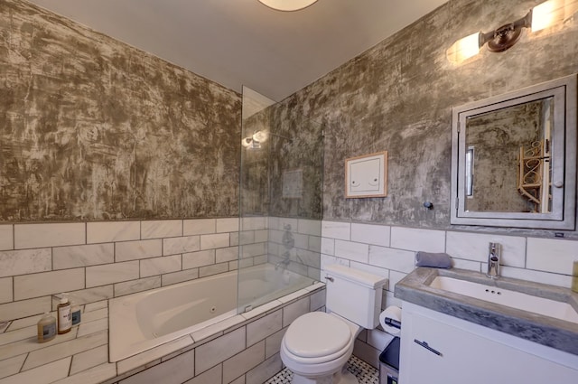 full bathroom with tile patterned floors, vanity, tiled shower / bath combo, tile walls, and toilet