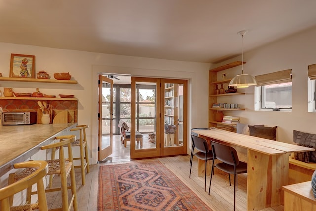 dining room featuring french doors and light hardwood / wood-style floors