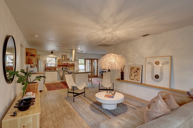 living room with light wood-type flooring and french doors