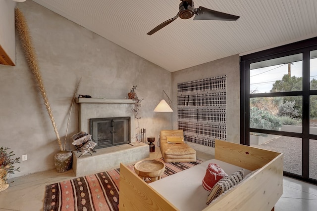 living area with vaulted ceiling and ceiling fan