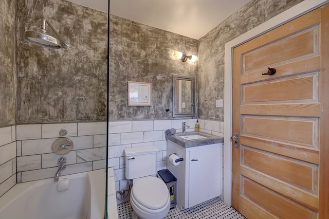 bathroom featuring tile patterned floors, vanity, tile walls, and toilet