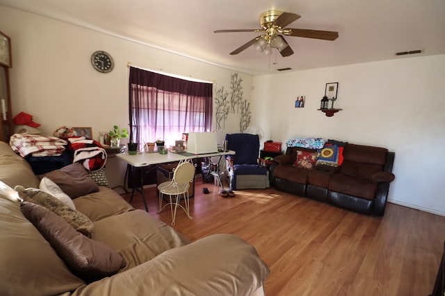 living room featuring ceiling fan and hardwood / wood-style flooring