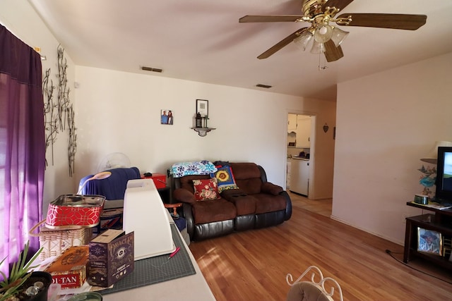 living room featuring ceiling fan and wood-type flooring