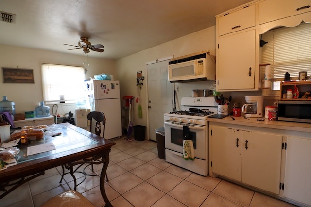 kitchen featuring light tile patterned floors, white appliances, white cabinetry, and ceiling fan