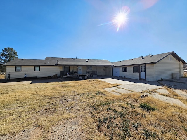 back of house with a lawn and a patio