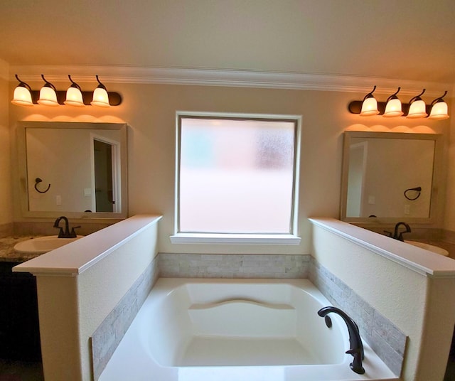 full bath featuring vanity, a garden tub, and ornamental molding