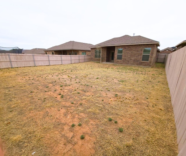 view of yard with a fenced backyard