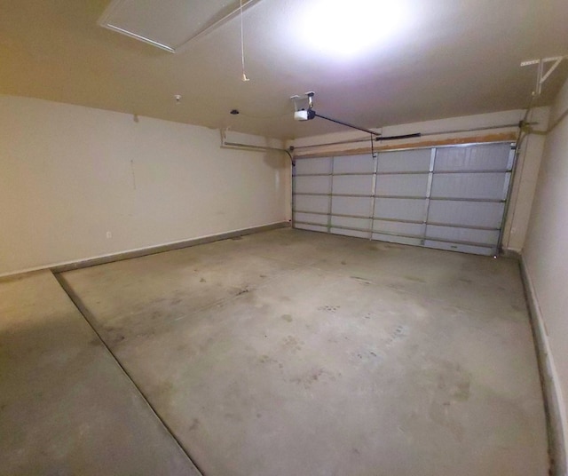 garage with baseboards and a garage door opener