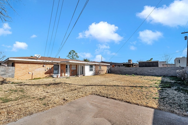 rear view of house featuring a yard