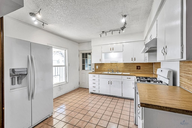 kitchen featuring white cabinetry, white appliances, sink, and a textured ceiling