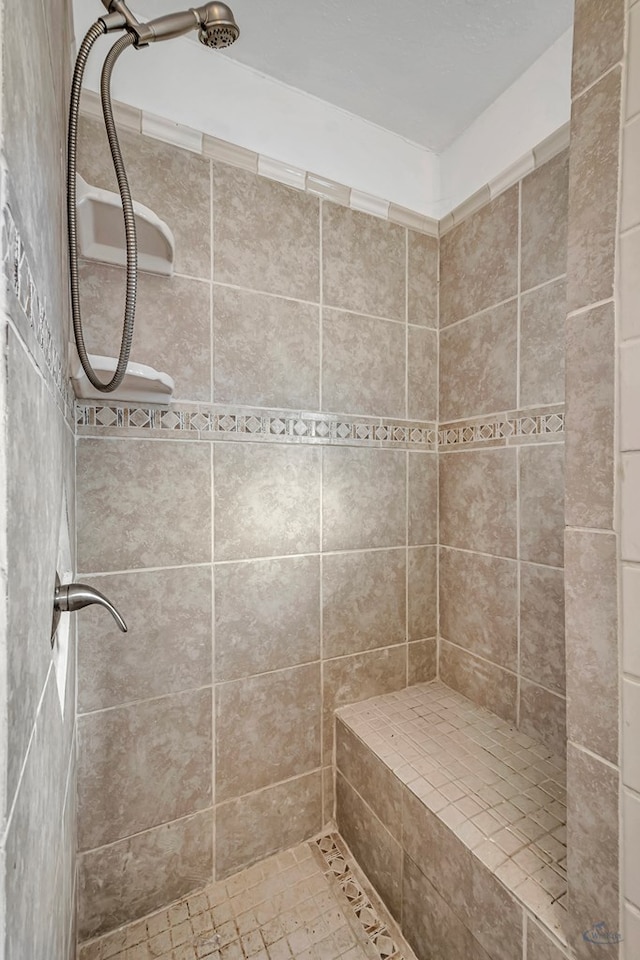 bathroom featuring tiled shower