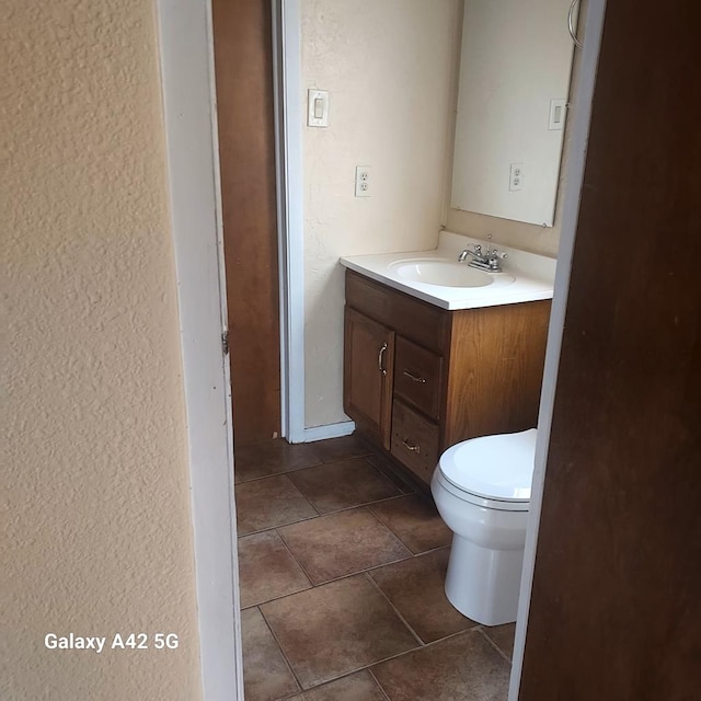 bathroom featuring tile patterned floors, toilet, and vanity