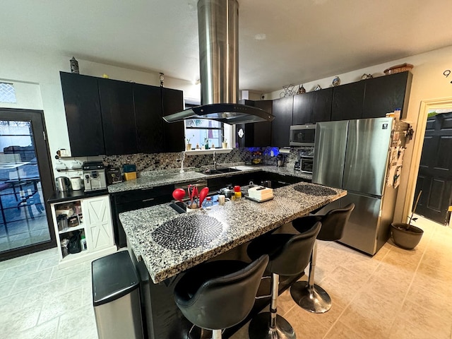 kitchen featuring backsplash, stainless steel appliances, a healthy amount of sunlight, and stone countertops