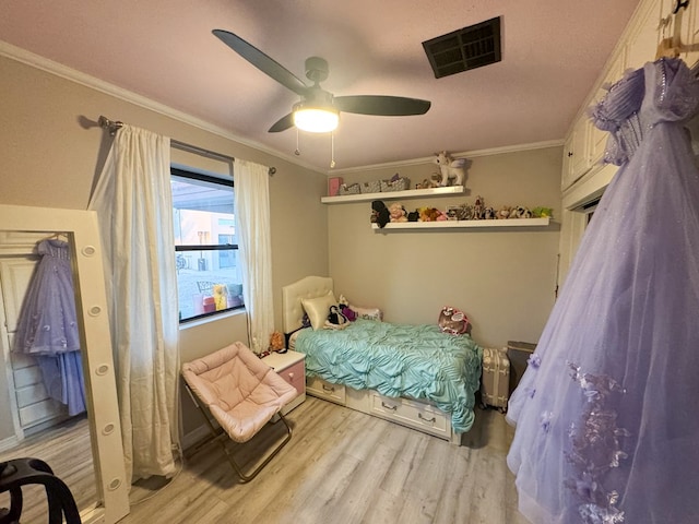 bedroom with ceiling fan, crown molding, and light hardwood / wood-style flooring