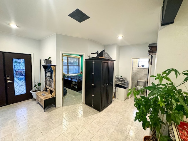 foyer featuring crown molding