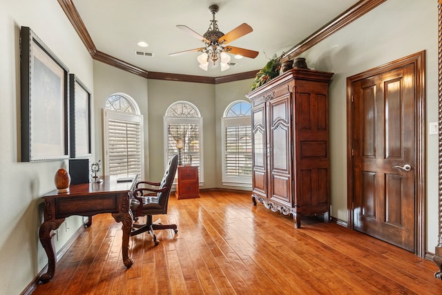 office space featuring ceiling fan, crown molding, and light wood-type flooring