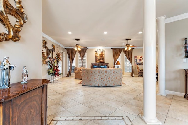 living room with ceiling fan, plenty of natural light, crown molding, and ornate columns