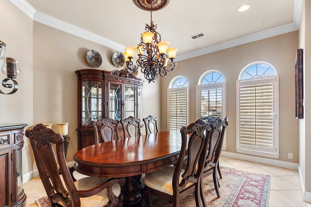 tiled dining space with crown molding and a notable chandelier