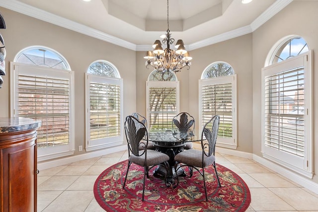 tiled dining area with plenty of natural light, a chandelier, crown molding, and a raised ceiling