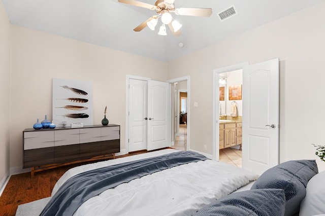 bedroom with ensuite bath, ceiling fan, and light wood-type flooring