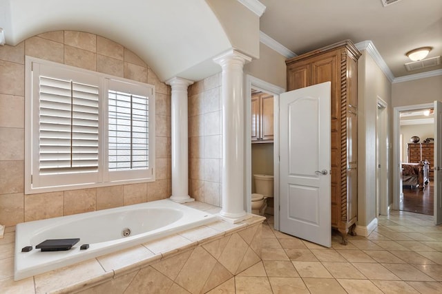 bathroom with tiled bath, toilet, ornamental molding, and tile patterned flooring