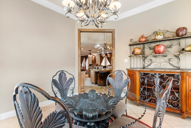 dining space with a notable chandelier, light tile patterned flooring, and ornamental molding