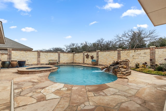 view of swimming pool featuring pool water feature, an in ground hot tub, and a patio