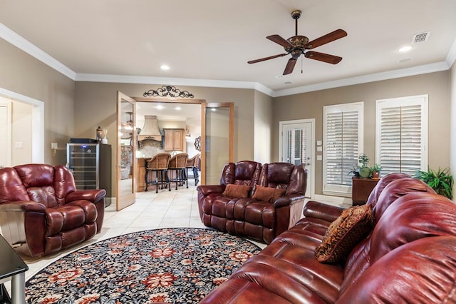 living room with ceiling fan, light tile patterned floors, and crown molding