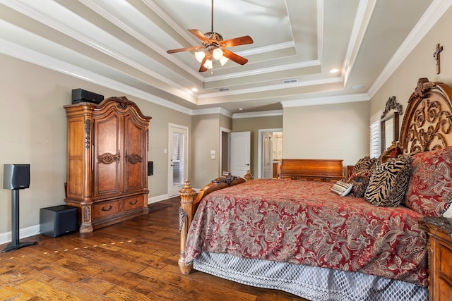 bedroom featuring ceiling fan, ornamental molding, dark hardwood / wood-style floors, and a tray ceiling