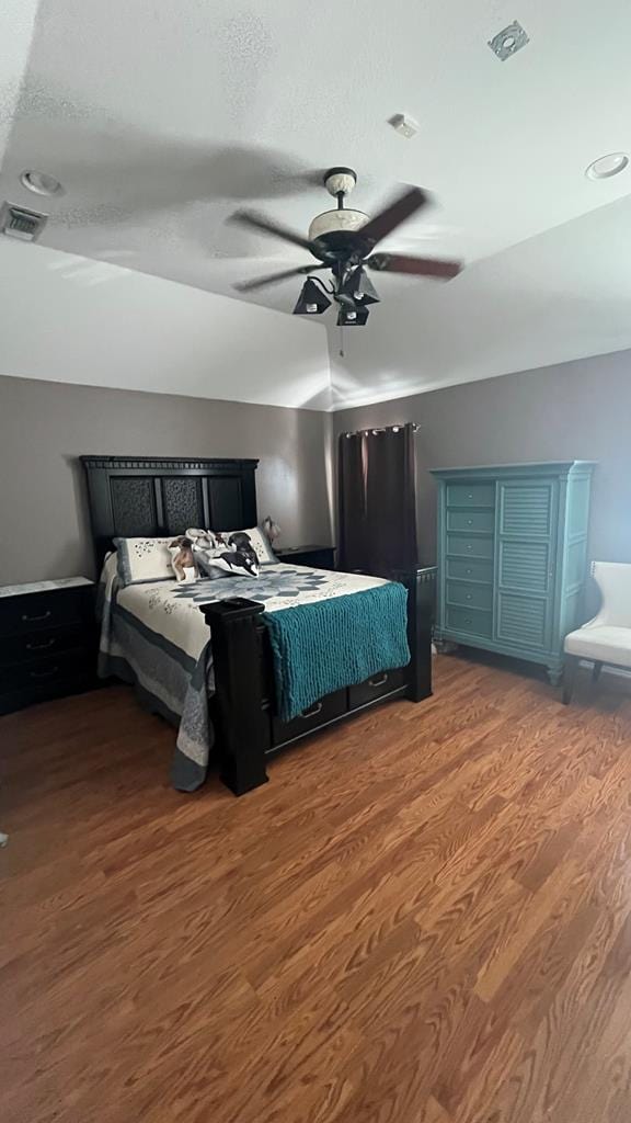 bedroom with ceiling fan and dark hardwood / wood-style floors