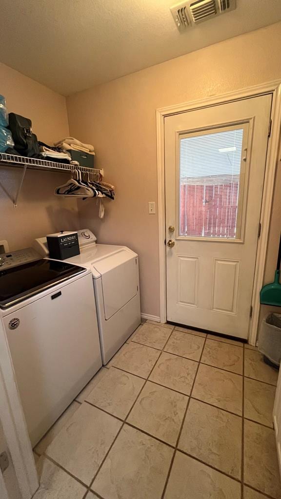 washroom with light tile patterned floors and independent washer and dryer