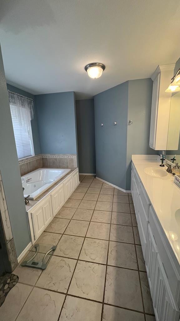 bathroom with a bathtub, tile patterned flooring, and vanity