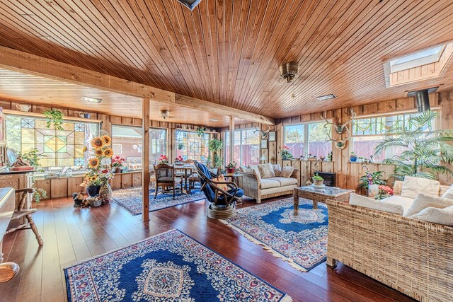 bedroom featuring ceiling fan, two closets, a textured ceiling, and light hardwood / wood-style flooring