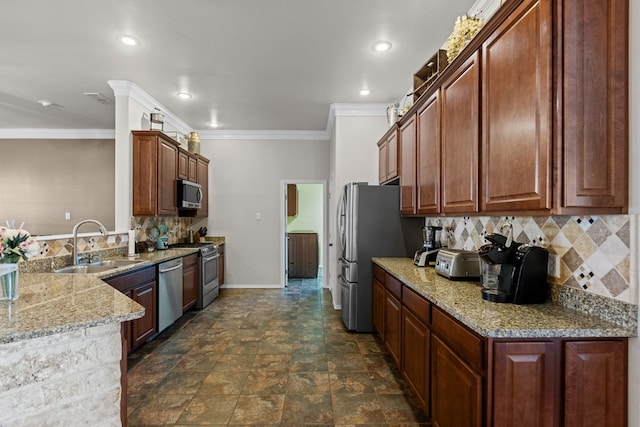 kitchen with sink, decorative backsplash, light stone countertops, ornamental molding, and appliances with stainless steel finishes