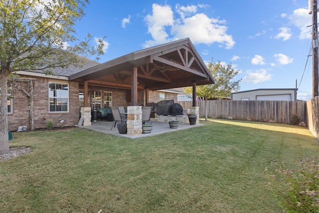 back of property featuring a lawn and a patio