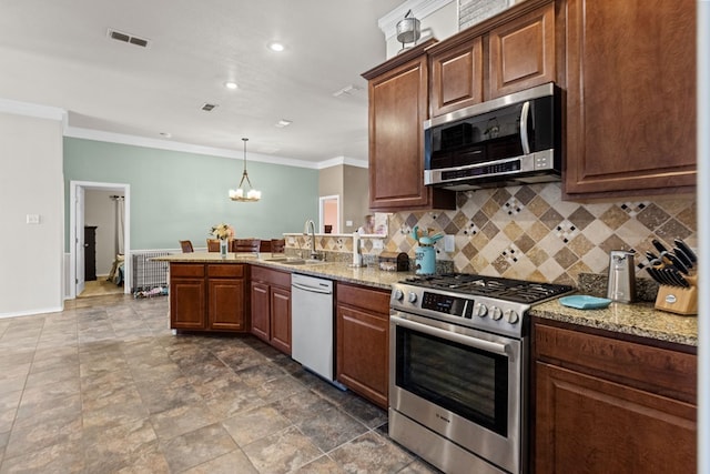 kitchen with light stone countertops, decorative backsplash, stainless steel appliances, sink, and a chandelier