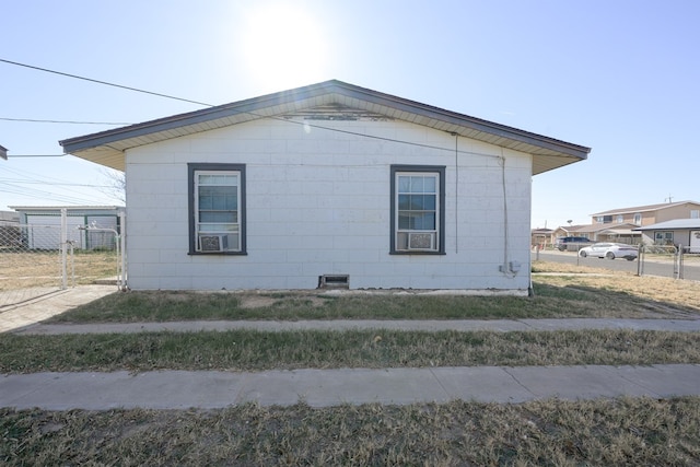 view of side of property featuring a yard and cooling unit