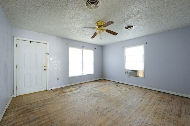 foyer with light hardwood / wood-style floors, ceiling fan, and cooling unit