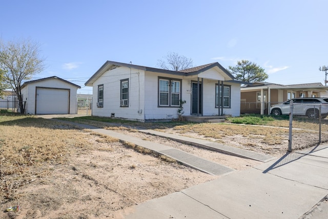 single story home featuring an outbuilding and a garage