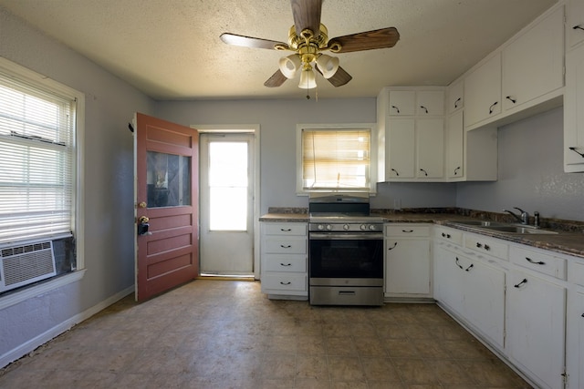 kitchen with white cabinets, range, a wealth of natural light, and sink