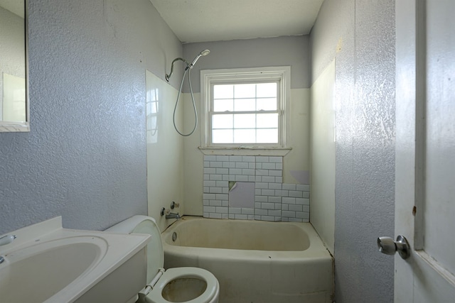 full bathroom featuring toilet, shower / washtub combination, and sink